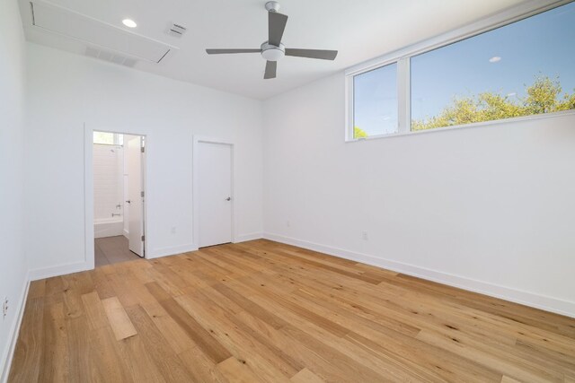 3201 Sunny Ln, Austin, TX 78731 - unfurnished bedroom with attic access, light wood finished floors, ensuite bathroom, and a ceiling fan