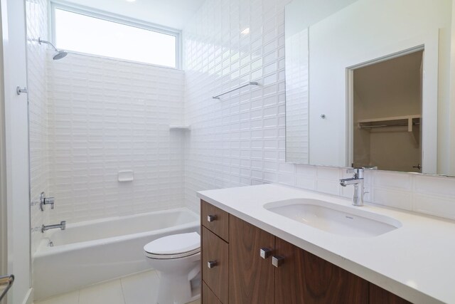 full bathroom with  shower combination, tile patterned floors, tile walls, toilet, and vanity