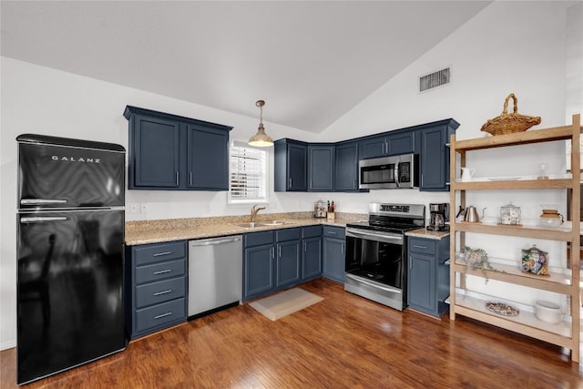 5898 River Oaks Dr, Kingsland, TX 78639 - kitchen with vaulted ceiling, a sink, appliances with stainless steel finishes, visible vents, and dark wood-type flooring