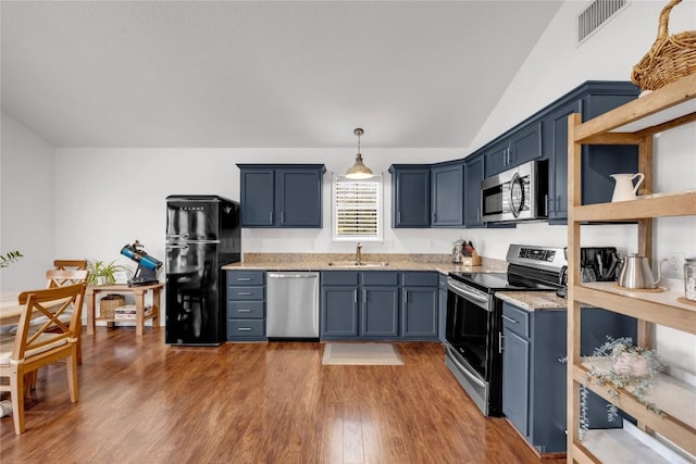 5898 River Oaks Dr, Kingsland, TX 78639 - kitchen with visible vents, wood finished floors, appliances with stainless steel finishes, a sink, and vaulted ceiling