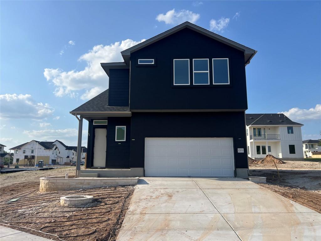 1703 Kit Cir, Austin, TX 78758 - view of front of house featuring a garage, driveway, and a residential view