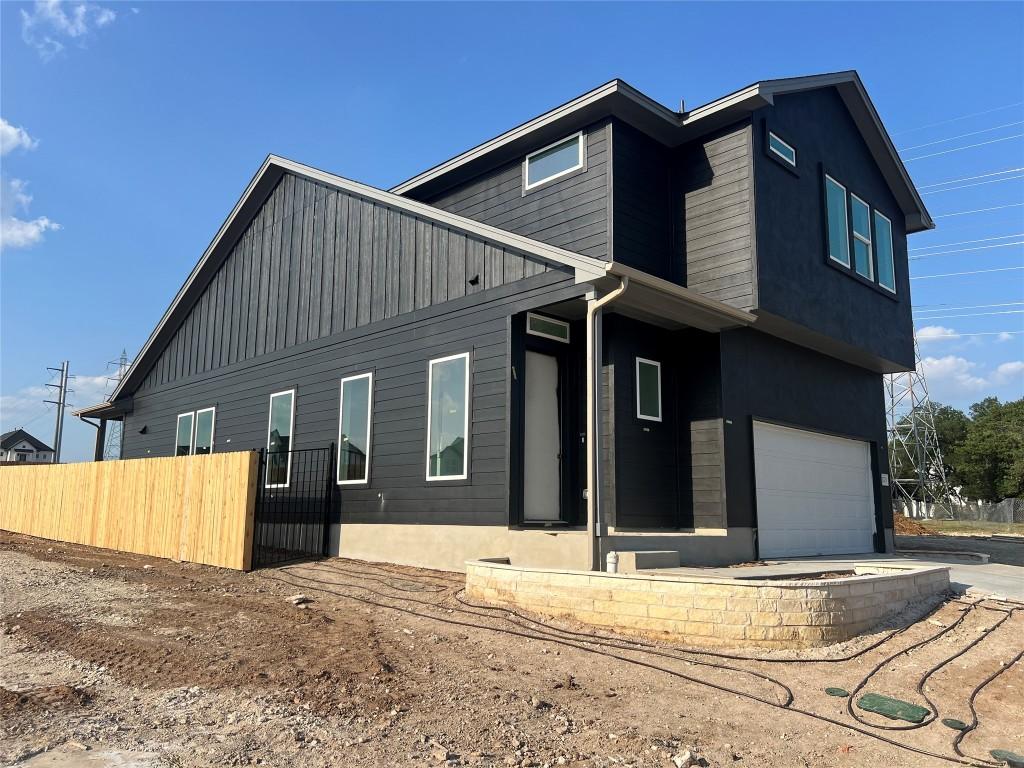 1703 Kit Cir, Austin, TX 78758 - view of side of property featuring a garage