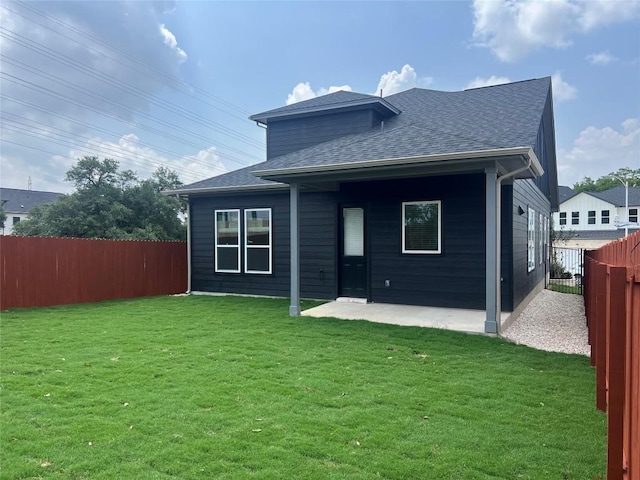 1703 Kit Cir, Austin, TX 78758 - rear view of house featuring a fenced backyard, roof with shingles, and a patio area