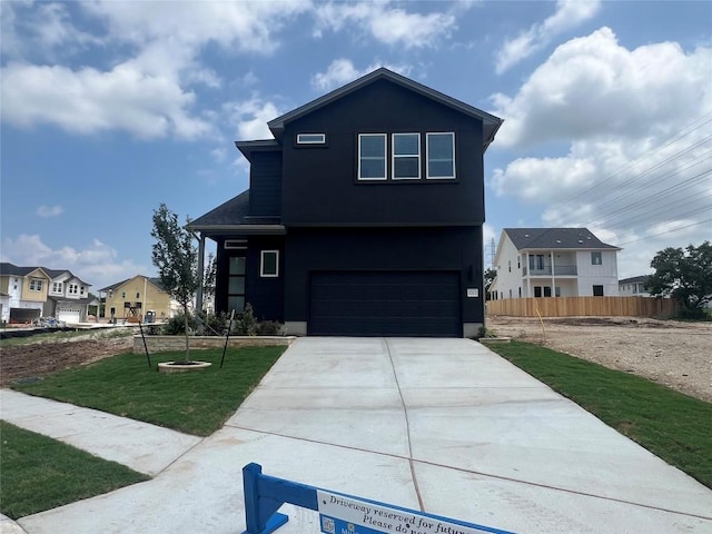1703 Kit Cir, Austin, TX 78758 - view of front facade featuring a garage, concrete driveway, and a residential view