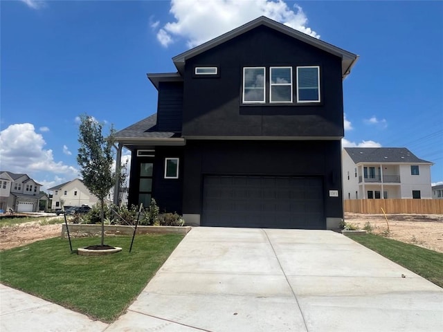 1703 Kit Cir, Austin, TX 78758 - view of front facade with an attached garage, concrete driveway, and a residential view
