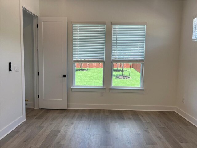 1703 Kit Cir, Austin, TX 78758 - spare room with wood finished floors and healthy amount of natural light