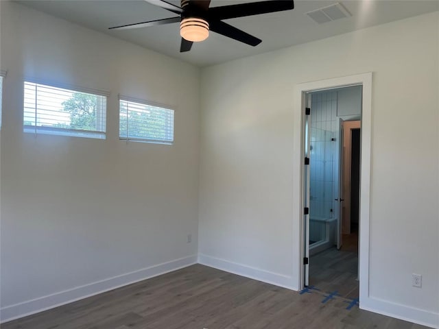 1703 Kit Cir, Austin, TX 78758 - empty room featuring ceiling fan and dark wood finished floors
