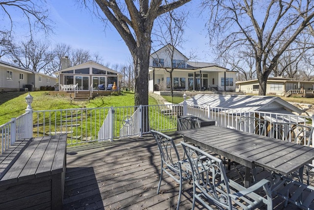 2546 Williams Lakeshore, Kingsland, TX 78639 - wooden terrace featuring outdoor dining area, a yard, and a sunroom