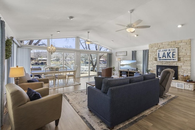 2546 Williams Lakeshore, Kingsland, TX 78639 - living area with ceiling fan, lofted ceiling, a stone fireplace, and wood finished floors