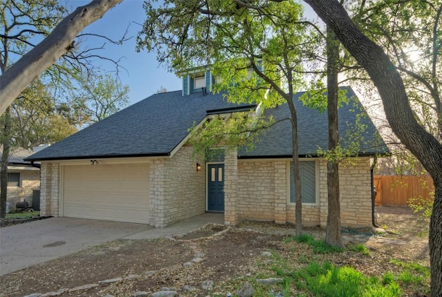 1701 Indian Camp Trl, Round Rock, TX 78681 - view of front of property with a shingled roof, a garage, driveway, and stone siding