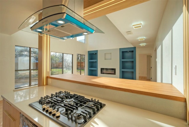 1701 Indian Camp Trl, Round Rock, TX 78681 - kitchen with stainless steel gas cooktop and island exhaust hood