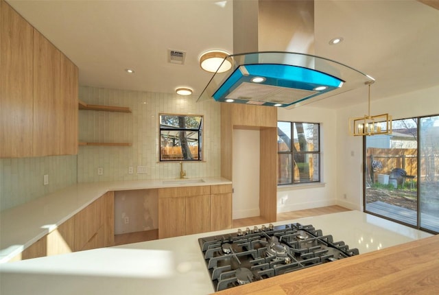 1701 Indian Camp Trl, Round Rock, TX 78681 - kitchen featuring modern cabinets, open shelves, light countertops, a chandelier, and light brown cabinets