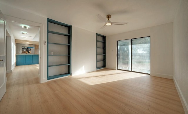 1701 Indian Camp Trl, Round Rock, TX 78681 - unfurnished room with a ceiling fan, light wood-style floors, and built in shelves