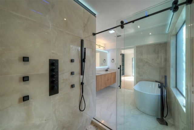 1701 Indian Camp Trl, Round Rock, TX 78681 - bathroom with a freestanding bath, vanity, a shower, marble finish flooring, and tile walls