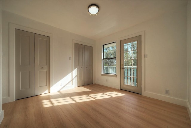 1701 Indian Camp Trl, Round Rock, TX 78681 - unfurnished bedroom with light wood-style flooring and access to exterior