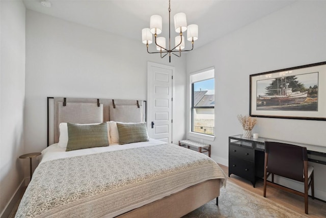 204 Ringtail Stream Dr, Lakeway, TX 78738 - bedroom with a chandelier, wood finished floors, and baseboards