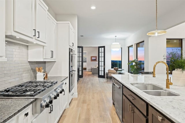 204 Ringtail Stream Dr, Lakeway, TX 78738 - kitchen with stainless steel appliances, a sink, white cabinetry, light stone counters, and recessed lighting