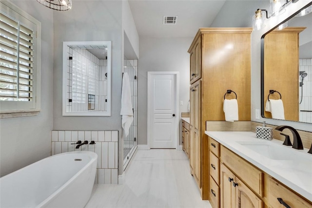 104 Standing Oak Dr, Georgetown, TX 78633 - bathroom featuring vanity, a shower stall, a freestanding tub, and marble finish floors