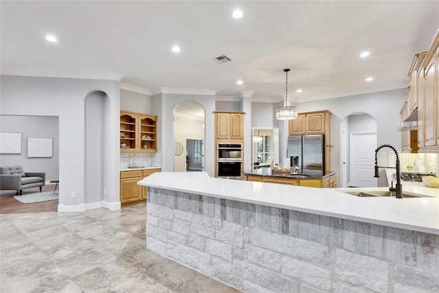 104 Standing Oak Dr, Georgetown, TX 78633 - kitchen with stainless steel appliances, arched walkways, a sink, tasteful backsplash, and recessed lighting