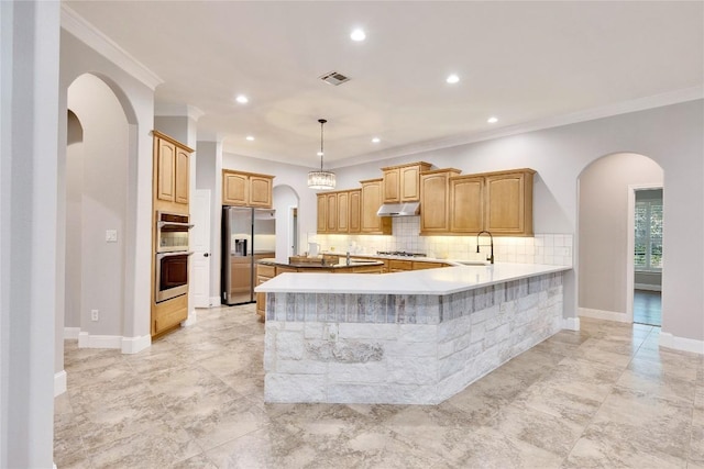 104 Standing Oak Dr, Georgetown, TX 78633 - kitchen with appliances with stainless steel finishes, arched walkways, under cabinet range hood, decorative backsplash, and a sink