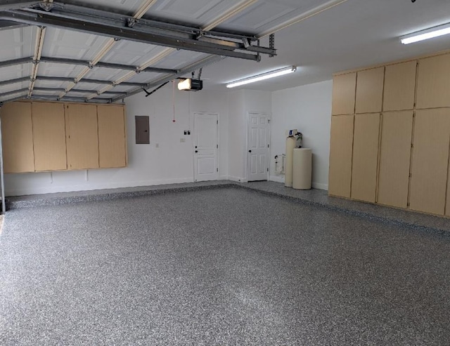 104 Standing Oak Dr, Georgetown, TX 78633 - garage featuring electric panel, a garage door opener, and baseboards