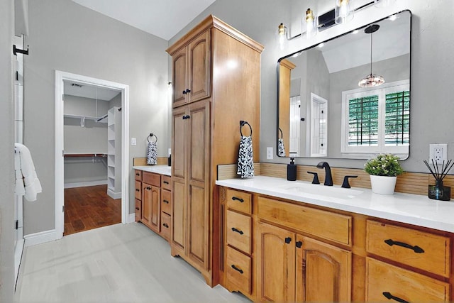 104 Standing Oak Dr, Georgetown, TX 78633 - bathroom with vanity, a spacious closet, and baseboards