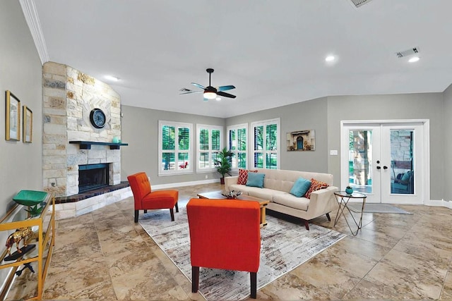 104 Standing Oak Dr, Georgetown, TX 78633 - living room with a ceiling fan, french doors, a fireplace, stone finish flooring, and ornamental molding