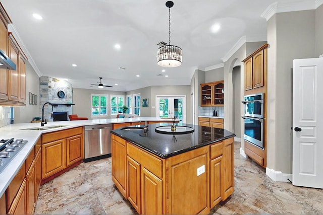 104 Standing Oak Dr, Georgetown, TX 78633 - kitchen with decorative backsplash, ornamental molding, appliances with stainless steel finishes, a center island, and recessed lighting