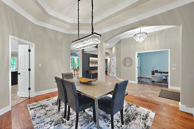 104 Standing Oak Dr, Georgetown, TX 78633 - dining space with arched walkways, plenty of natural light, crown molding, a chandelier, and wood finished floors