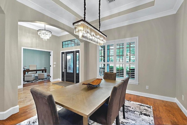 104 Standing Oak Dr, Georgetown, TX 78633 - dining room featuring a chandelier, baseboards, ornamental molding, wood finished floors, and arched walkways