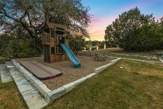 1420 Mirador, Leander, TX 78641 - playground at dusk featuring a lawn