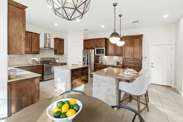 1420 Mirador, Leander, TX 78641 - kitchen with stainless steel appliances, wall chimney range hood, a kitchen island, backsplash, and light tile patterned flooring