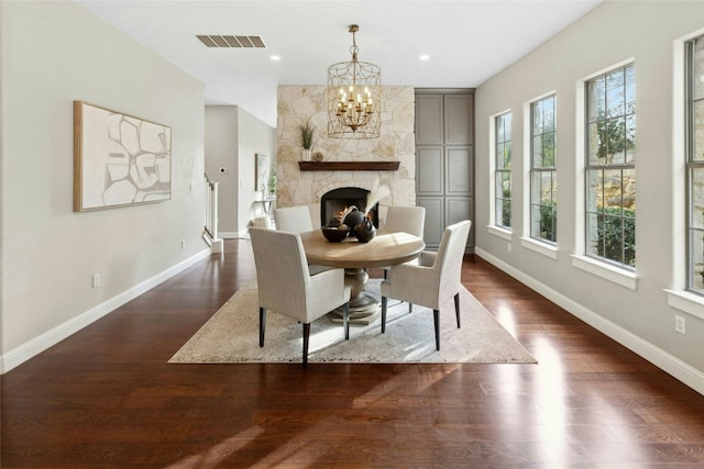 1420 Mirador, Leander, TX 78641 - dining area featuring a chandelier, dark wood-style flooring, a fireplace, and recessed lighting