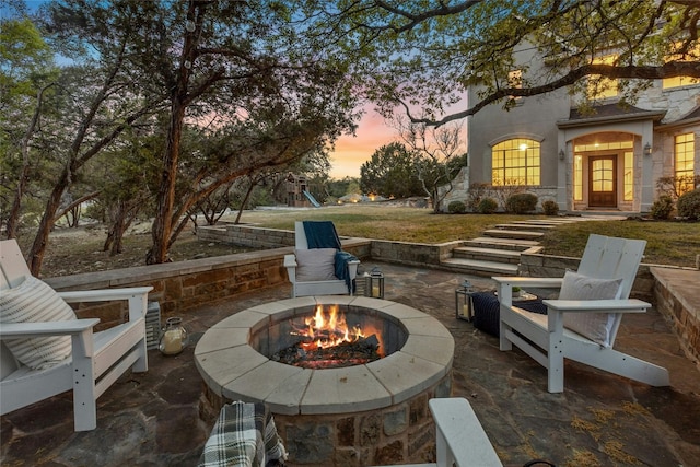1420 Mirador, Leander, TX 78641 - patio terrace at dusk with a fire pit, a playground, a patio area, and a yard