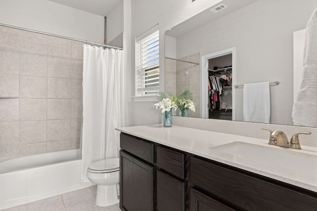 217 Timber Brook Dr, Hutto, TX 78634 - full bathroom with tile patterned flooring, vanity, shower / bath combination with curtain, and a walk in closet
