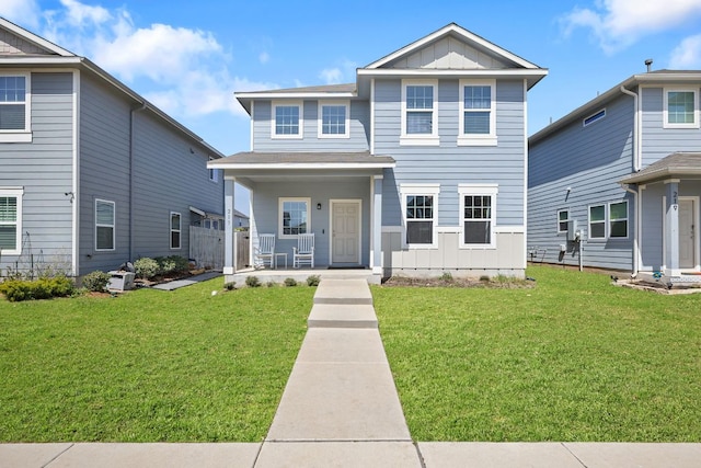217 Timber Brook Dr, Hutto, TX 78634 - traditional home featuring board and batten siding, a porch, and a front lawn