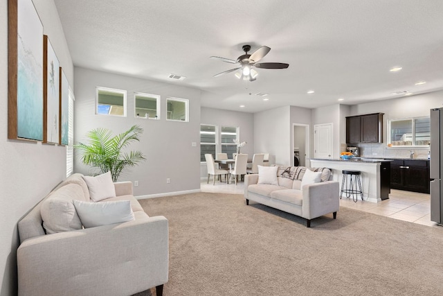 217 Timber Brook Dr, Hutto, TX 78634 - living area featuring light carpet, ceiling fan, and recessed lighting