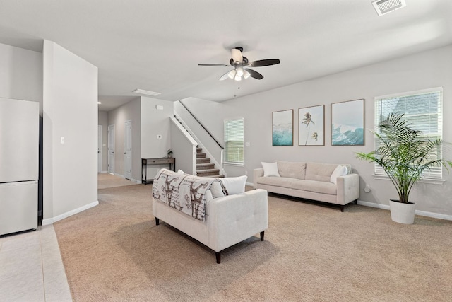 217 Timber Brook Dr, Hutto, TX 78634 - living area featuring light carpet, a ceiling fan, and stairway