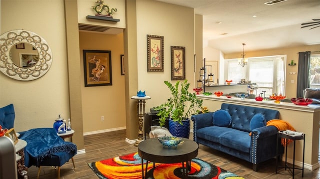 14811 Bescott Dr, Austin, TX 78728 - living room with wood tiled floors, baseboards, and a chandelier