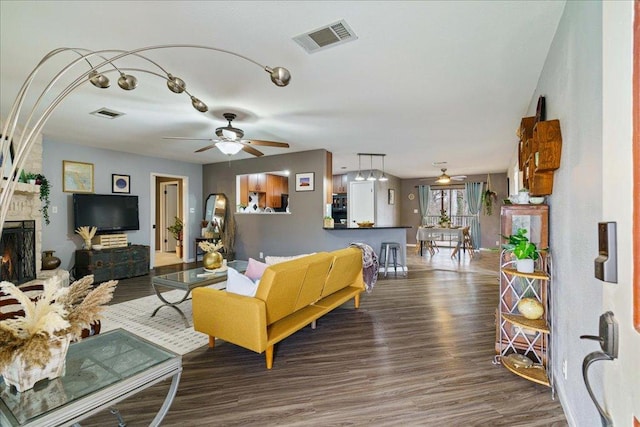 5014 Little Valley Rd, Leander, TX 78641 - living area featuring wood finished floors, ceiling fan, and a fireplace