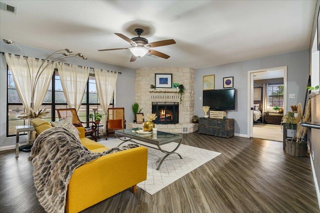 5014 Little Valley Rd, Leander, TX 78641 - living area featuring ceiling fan, a stone fireplace, and wood finished floors