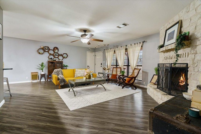 5014 Little Valley Rd, Leander, TX 78641 - living area with a ceiling fan, dark wood-type flooring, and a stone fireplace
