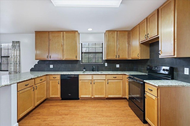 5014 Little Valley Rd, Leander, TX 78641 - kitchen featuring black appliances, a peninsula, light wood finished floors, light stone countertops, and backsplash