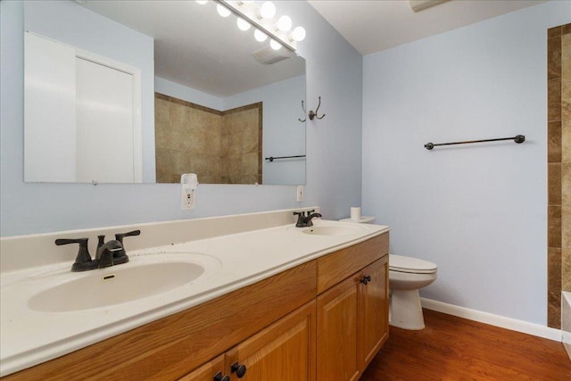 5014 Little Valley Rd, Leander, TX 78641 - bathroom featuring double vanity, wood finished floors, and tiled shower