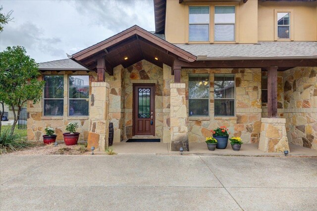 10242 Brangus Rd, Driftwood, TX 78619 - entrance to property featuring stone siding and a shingled roof