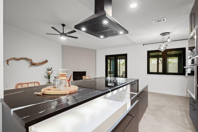 3503 Gable Dr, Austin, TX 78759 - kitchen featuring wall chimney range hood, black electric cooktop, a ceiling fan, pendant lighting, and french doors