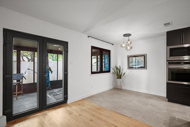 3503 Gable Dr, Austin, TX 78759 - unfurnished dining area with french doors, a chandelier, and light wood finished floors