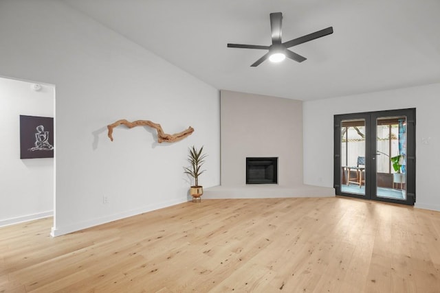 3503 Gable Dr, Austin, TX 78759 - unfurnished living room featuring wood finished floors, a ceiling fan, a glass covered fireplace, and french doors