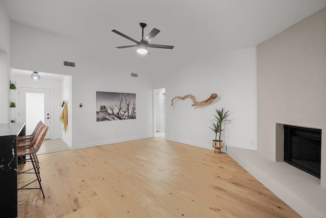 3503 Gable Dr, Austin, TX 78759 - living area with light wood-type flooring, a glass covered fireplace, and ceiling fan