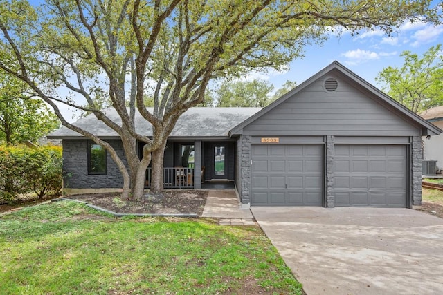 3503 Gable Dr, Austin, TX 78759 - ranch-style home with driveway, a garage, stone siding, a front yard, and a porch